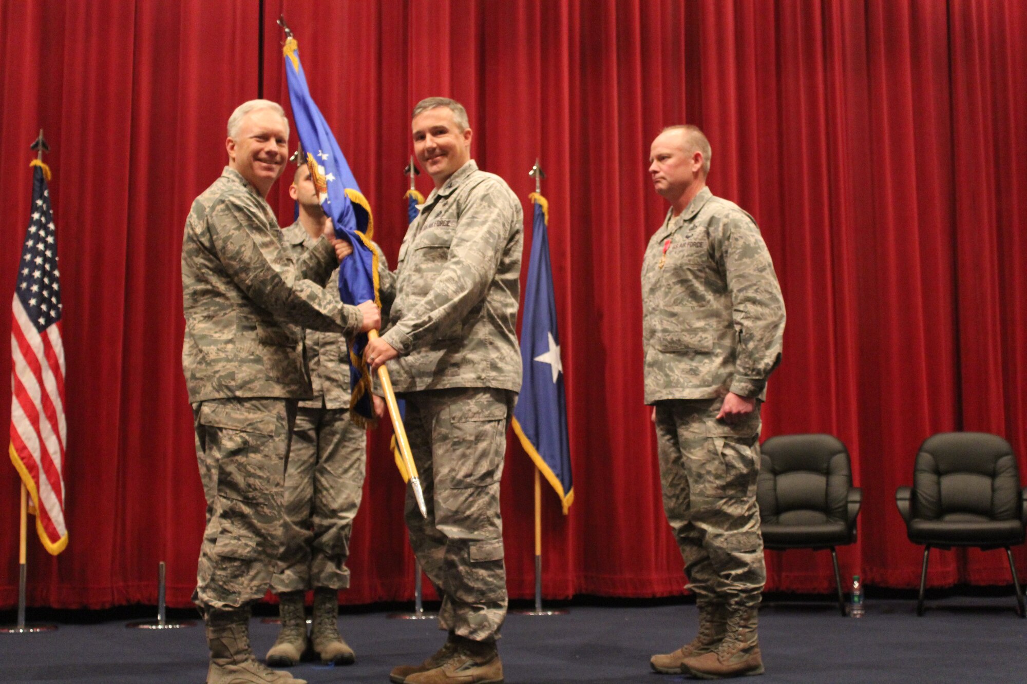 Lt. Gen. John Thompson, commander, Air Force Life Cycle Management Center (L) passes guidon to Col. Martin O’Grady (R). O’Grady is the new Program Executive Officer for the Intelligence, Surveillance, Reconnaissance and Special Operations Forces Directorate with AFLCMC. In this role he is responsible for supporting all Air Force ISR and SOF platforms to include RQ-4 Global Hawk and MQ-1 and M-9 Predator and Reaper. (Courtesy photo)