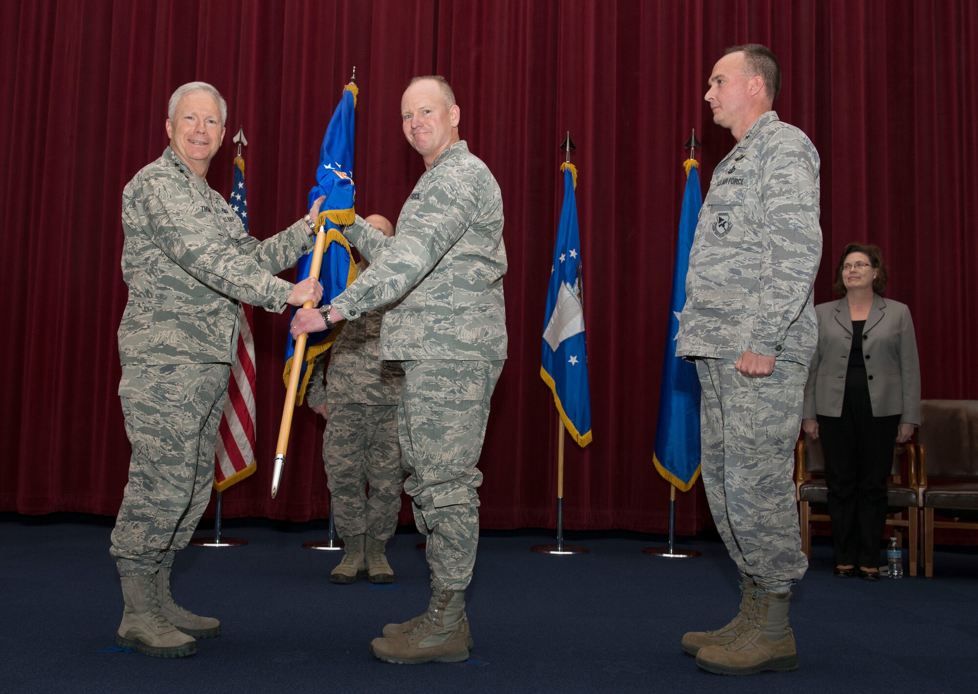 Lt. Gen. John Thompson, commander, Air Force Life Cycle Management Center (L), passes guidon to Brig. Gen. Michael Schmidt (R) during an April 8 change of leadership ceremony. Schmidt is the new Program Executive Officer for the Fighters and Bombers Directorate and is responsible for the development, production, fielding, sustainment and modernization of fighters and bombers throughout the Air Force fleet. In addition he is also responsible for organizing, training, and equipping the F-35 System Program Office.
 (U.S. Air Force photo by Michelle Gigante)

