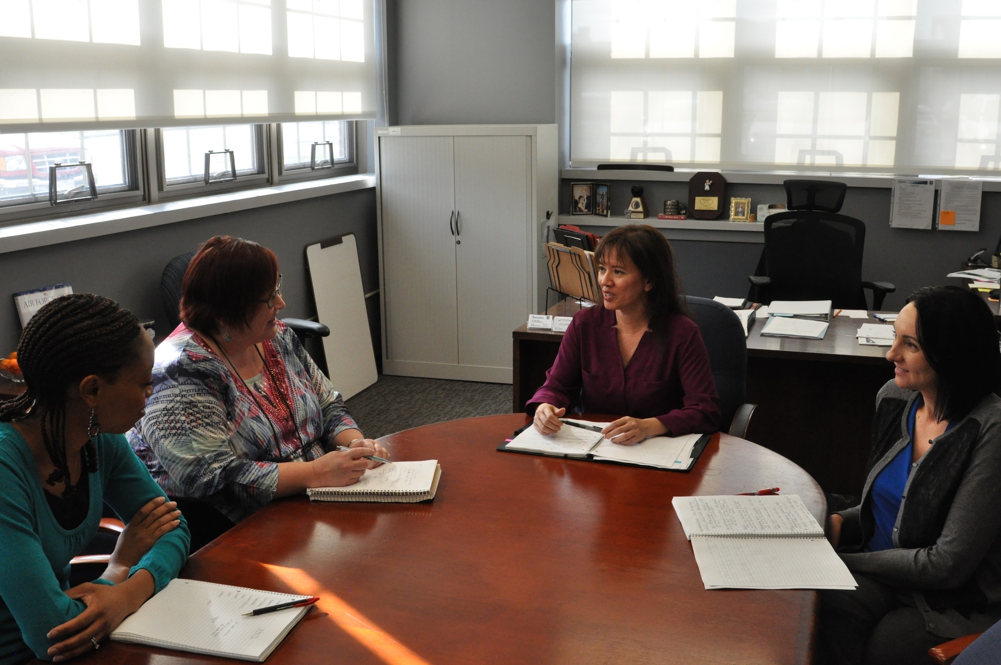 Photo Caption:  Dr. Mary Haley (center), director of the Air Force Life Cycle Management Center’s Office of Small Business and members of her team including Alicia Draines (left), Angela Arnold and Kelly Thirtyacre (right)  discuss small business during a March 14 meeting. (U.S. Air Force photo/Brian Brackens)
