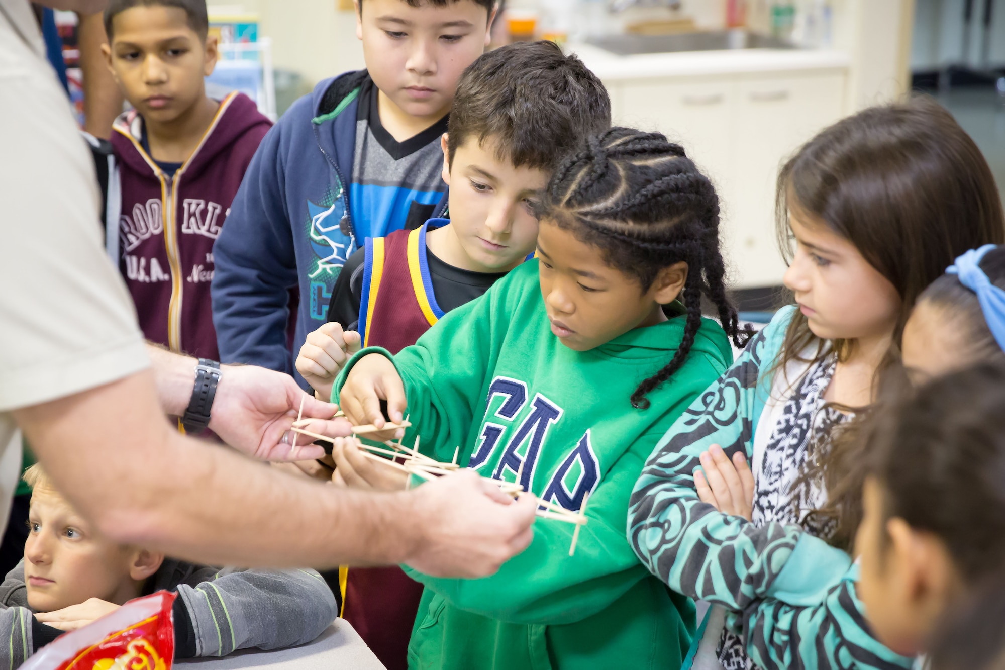 DOD students build a popsicle stick and toothpick truss bridge during a Science, Technology, Engineering, and Math (STEM) workshop March 24, 2016, at Camp Kinser, Japan. DoD schools advocate classes and clubs such as robotics courses to encourage student interest in science, technology, engineering and mathematics. (Courtesy Photo)