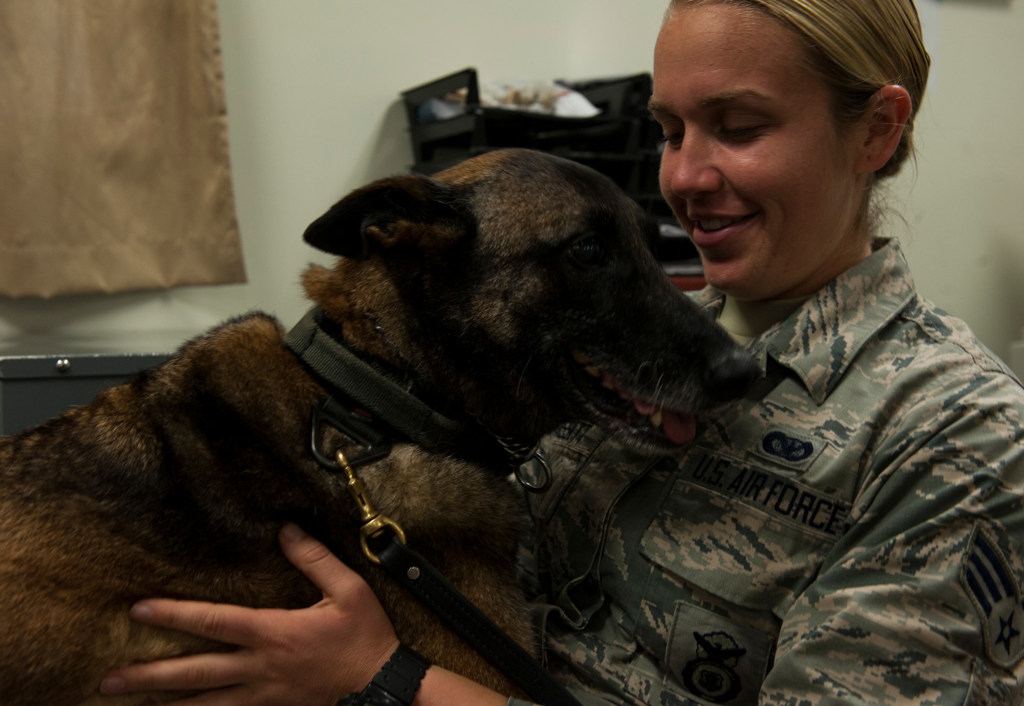 U.S. Air Force Senior Airman Rena Bissett, 18th Security Forces Squadron Military Working Dog handler, compliments her MWD, Judi, for good behavior April 13, 2016, at Kadena Air Base, Japan. MWDs are trained to work with their handlers and obey their commands. (U.S. Air Force photo by Airman 1st Class Lynette M. Rolen)