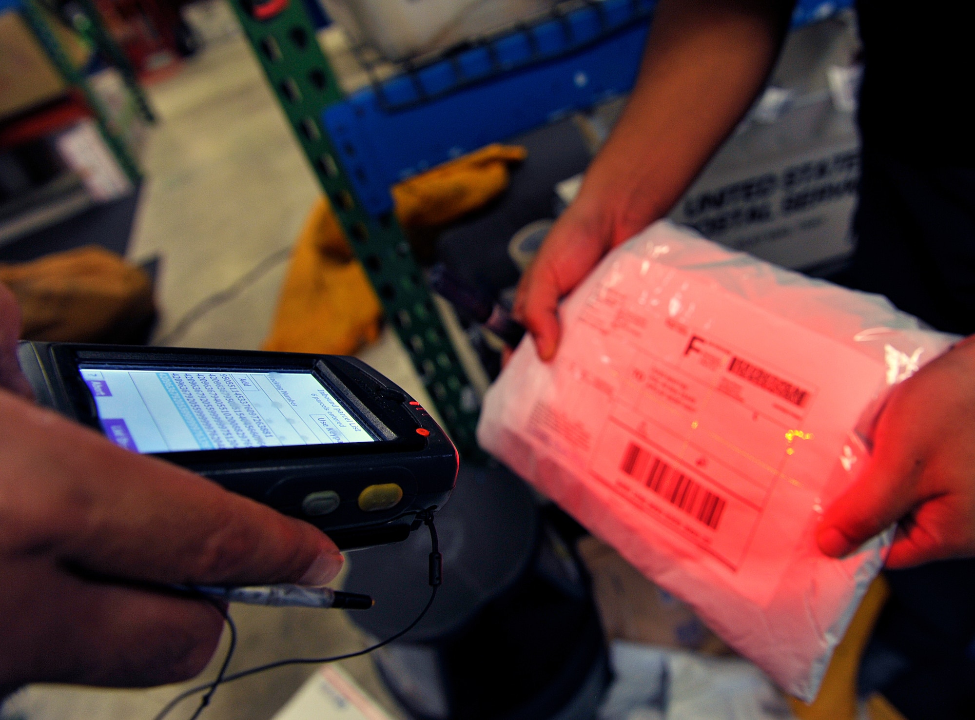 A Japanese employee from the Kadena Post Office scans a barcode from mail to get tracking information at the Kadena Air Base Post Office April 12, 2016, at Kadena Air Base, Japan. The post office job includes sorting mail, loading and unloading trucks with packages and giving parcels to customers. (U.S. Air Force photo by Naoto Anazawa)




