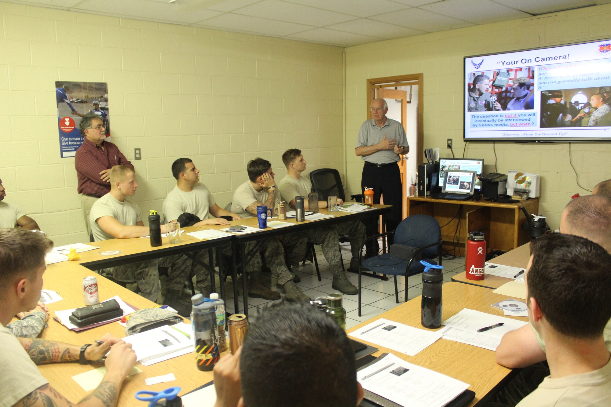 Firefighters from the 612th Air Base Squadron listen as instructor Joe Allred (far right), United States Air Force Expeditionary Center instructor, teaches a class on Public Affairs during an Air Advisor course as part of the preparations for the Central America Sharing Mutual Operational Knowledge and Experiences exercise at Soto Cano Air Base, Honduras, April 1, 2016. The training lasted a week and involved diverse lessons including Mesoamerican Religions, Foreign Disclosure, and Cross Cultural Communications & Negotiations. (U.S. Army photo by Maria Pinel/Released)