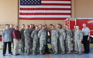 Servicemembers from the 612th Air Base Squadron Fire Department pose for a group photo after completing an Air Advisor course taught by Mr. Greg Kruse (far left), Mr. Dave Enriquez (left), and Mr. Joe Allred (far right), United States Air Force Expeditionary Center instructors April 1, 2016, at Soto Cano Air Base, Honduras. The course included diverse lessons such as Mesoamerican Religions, Foreign Disclosure, Cross Cultural Communications & Negotiations, and Public Affairs, as part of previous preparation to the Central America Sharing Mutual Operational Knowledge and Experiences exercise hosted by Joint Task Force-Bravo that involves firefighters from all across Central America. (U.S. Army photo by Maria Pinel/Released)  