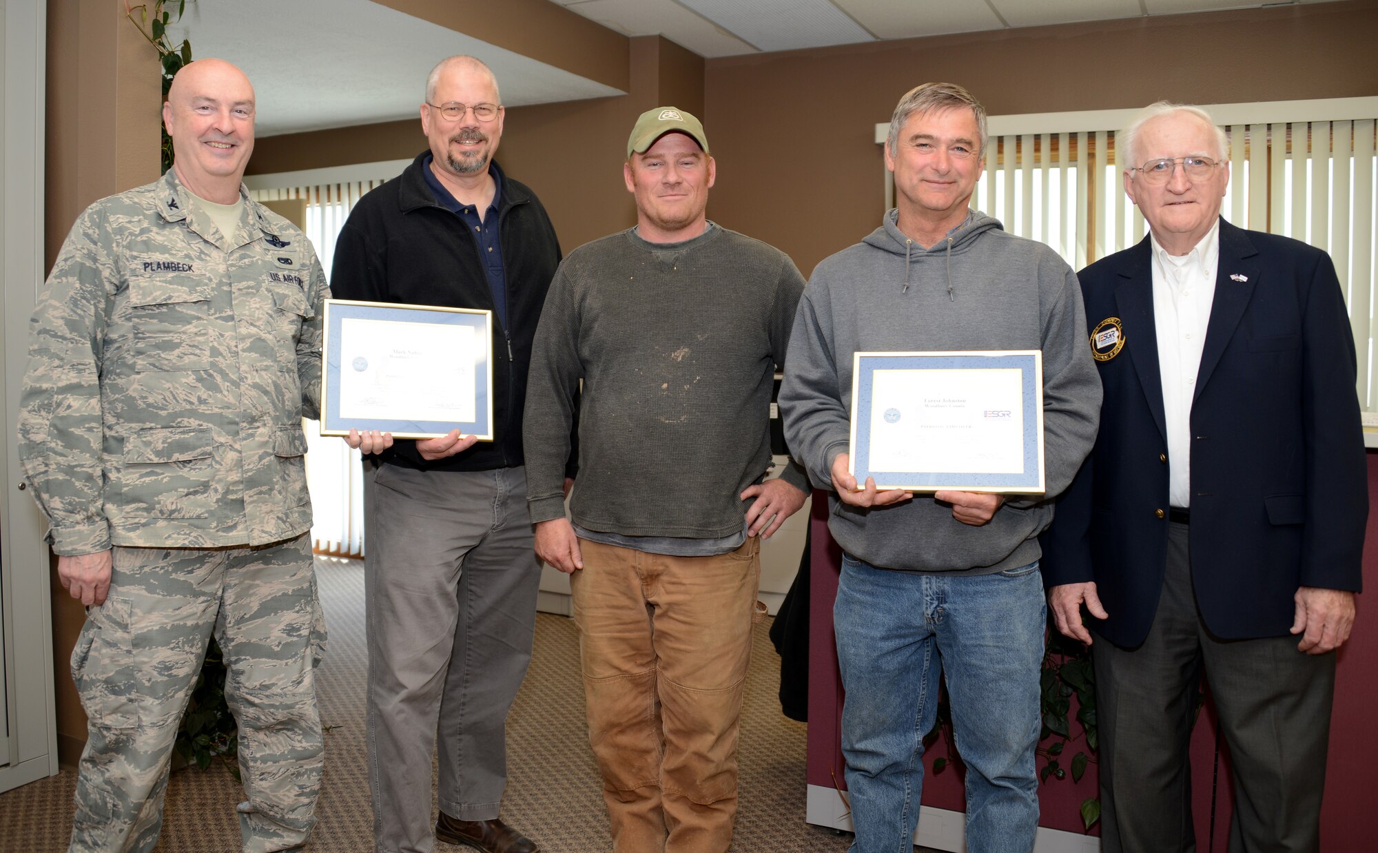 Employee Support of the Guard and Reserve  representative Mr. Larry Harrington (right) along with Col. Scott Plambeck, Iowa Air National Guard (left) present an ESGR “Patriotic Employer” award to Mr. Mark Nahra and Mr. Forest Johnston of the Woodbury County Engineers office in Moville, IA on Wednesday April 13, 2016. Nahra and Johnston were nominated for the award by Senior Airman Pete McDermott (center). McDermott works full time for Woodbury County, but also serves as a member of the Iowa Air National Guard with the 185th Air Refueling Wing in Sioux City, IA. (U.S. Air National Guard photo by Master Sgt. Vincent De Groot/Released)
