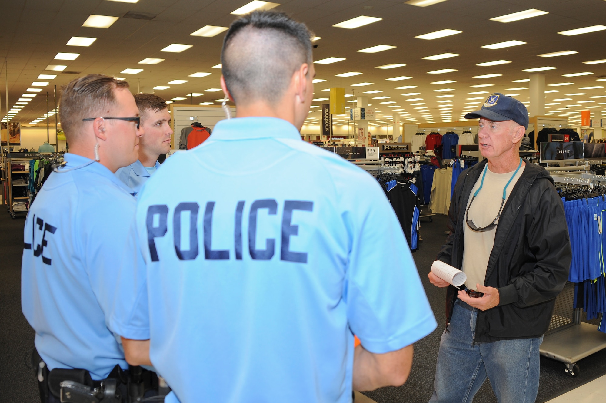 Retired U.S. Air Force Lt. Col. Gary Hopper speaks with 355th Security Forces Squadron bicycle patrol fleet members about their mission at Davis-Monthan Air Force Base, Ariz., April 8, 2016. Communicating and interacting with the base community is a main objective of the 355th SFS bicycle fleet. (U.S. Air Force photo by Airman 1st Class Mya M. Crosby/Released)