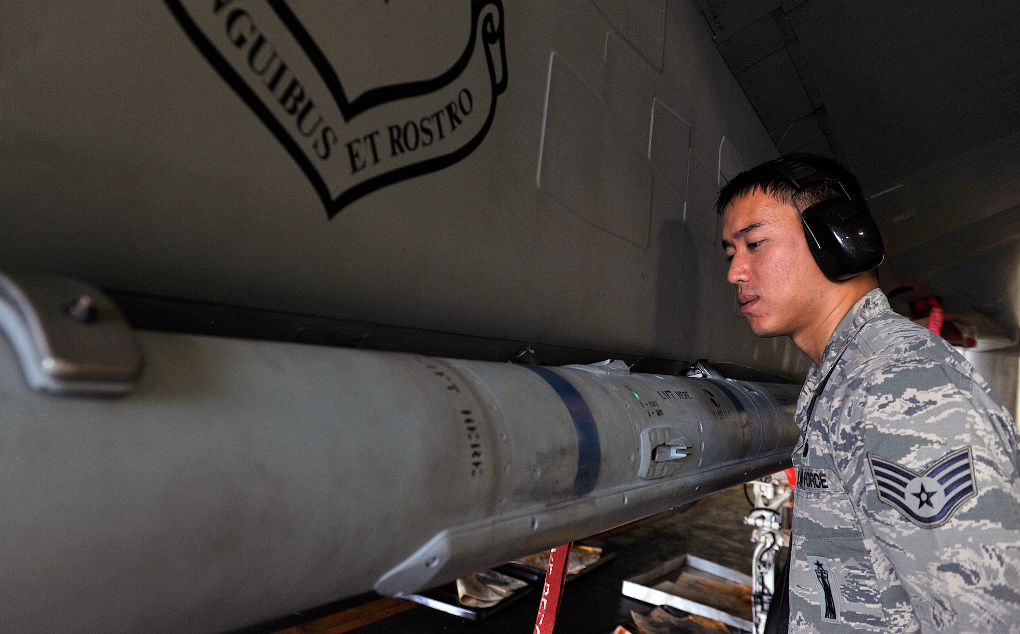 U.S. Air Force Staff Sgt. Paolo Santos, 18th Maintenance Group loading standardization crew, inspects an AIM-120 advanced medium-range air-to-air missile during weapons load training April 13, 2016, at Kadena Air Base, Japan. The 18th Maintenance Group prepares each aircraft for flight to ensure safety and reliability in support of the training mission here at Kadena. (U.S. Air Force photo by Naoto Anazawa)