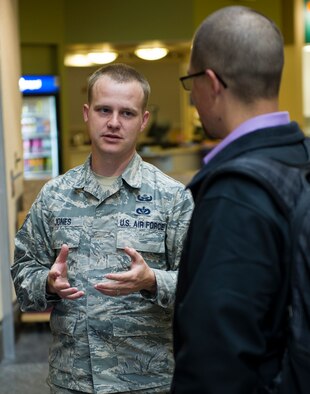 Staff Sgt. Christopher Jones, 92nd Civil Engineering Squadron Explosive Ordnance Disposal journeyman, talks with an Attendee of North Idaho College’s Science, Technology, Engineering and Math Expo April 12, 2016, in Coeur d’Alene, Idaho. Fairchild EOD has made similar presentations at recruiter stations, ROTC squadrons and high schools. (U.S. Air Force photo/Airman 1st Class Sean Campbell) 
