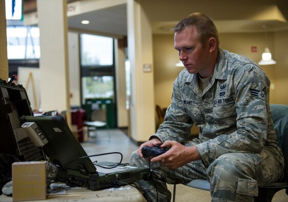 Senior Airman Jeremy Weant, 92nd Civil Engineering Squadron Explosive Ordnance Disposal journeyman, operates a robot during North Idaho College’s Science, Technology, Engineering and Math Expo April 12, 2016, in Coeur d’Alene, Idaho. Along with the robots, EOD brought a bomb suit that gives students the perspective of how heavy it is for EOD Airmen to wear on a daily basis and how it protects them. (U.S. Air Force photo/Airman 1st Class Sean Campbell)