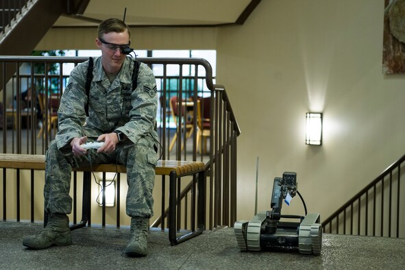 Senior Airman Steven Taylor, 92nd Civil Engineering Squadron Explosive Ordnance Disposal journeyman, operates a robot to demonstrate to attendees of North Idaho College’s Science, Technology, Engineering and Math Expo April 12, 2016, in Coeur d’Alene, Idaho. Attendees of the expo were allowed to operate and interact with the robots. (U.S. Air Force photo/Airman 1st Class Sean Campbell)