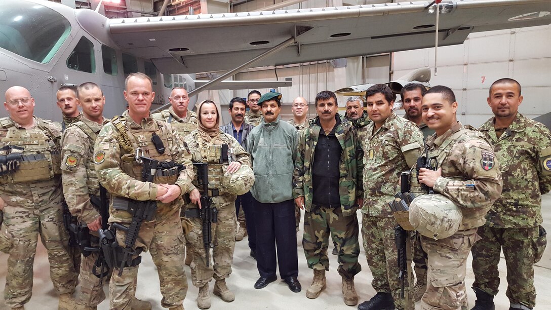 Train, Advise, Assist Command-Air (TAAC-Air) maintenance advisors pose with some of their Afghan air force maintenance counterparts at an aircraft hangar at Hamid Karzai International Airport, Kabul, Afghanistan, March 2016. TAAC-Air coalition advisors work daily to train, advise, and assist their Afghan partners to develop a professional, capable, and sustainable air force. (U.S. Air Force photo by Staff Sgt. Steven Marquez/released) 