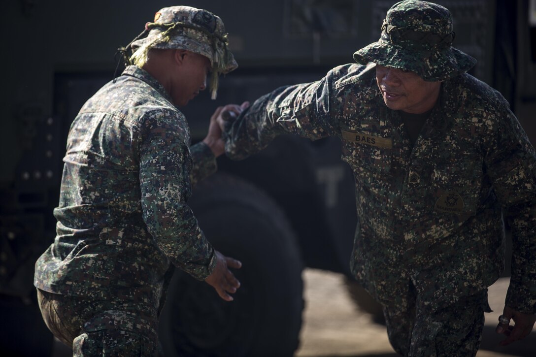 Filipino Marines, Cpl. Richard Sumalileng, and SSgt. Bonifacio Baes, both with 4th Marine Regiment conduct a demonstration of martial arts for the U.S. Marines during Balikatan 2016 (BK 16) on April 9, 2016.  The purpose of BK 16 is to strengthen interoperability and partner-nation capabilities for the planning and execution of military operations, and advance regional security operations.
