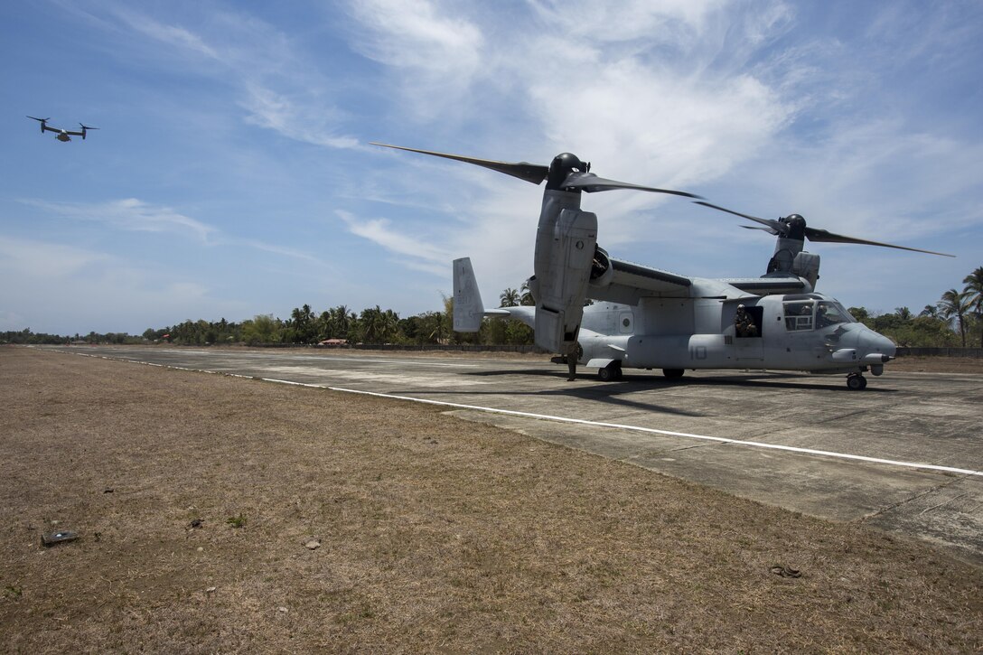 U.S. MV-22 Ospreys land on Antique Airfield during a simulated airfield insert U.S. Marines with 2d Battalion, 2d Marine Regiment, Golf Company, walk to the Entry Control Command while executing a simulated airfield insert during Balikatan 2016 (BK 16) on April 11, 2016.  The purpose of BK 16 is to strengthen interoperability and partner-nation capabilities for the planning and execution of military operations, and advance regional security operations. 