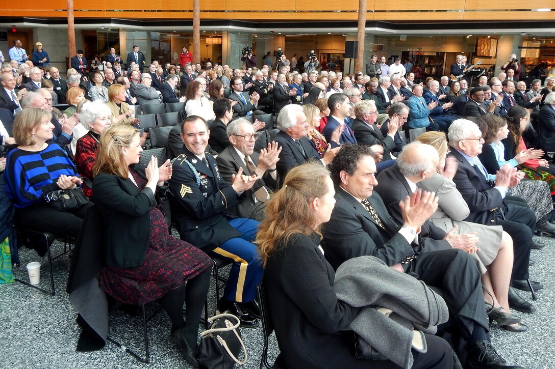 Attendees applaud former U.S. Sen. Carl M. Levin during a ceremony in which the Navy’s newest Arleigh Burke class destroyer, DDG 120, was named in his honor in Detroit, April 11, 2016. Navy Secretary Ray Mabus also participated. The ship will be constructed at Bath Iron Works in Maine and is expected to enter the Navy fleet in 2020. Navy photo by Lt. Kristine Volk