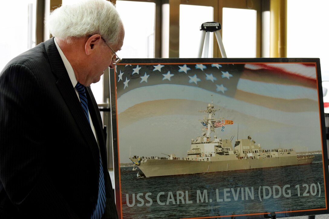 Former U.S. Sen. Carl M. Levin views a graphic representation of the Arleigh Burke class destroyer named in his honor by during a ceremony in Detroit, April 11, 2016. Navy photo by Chief Linda J. Andreoli
