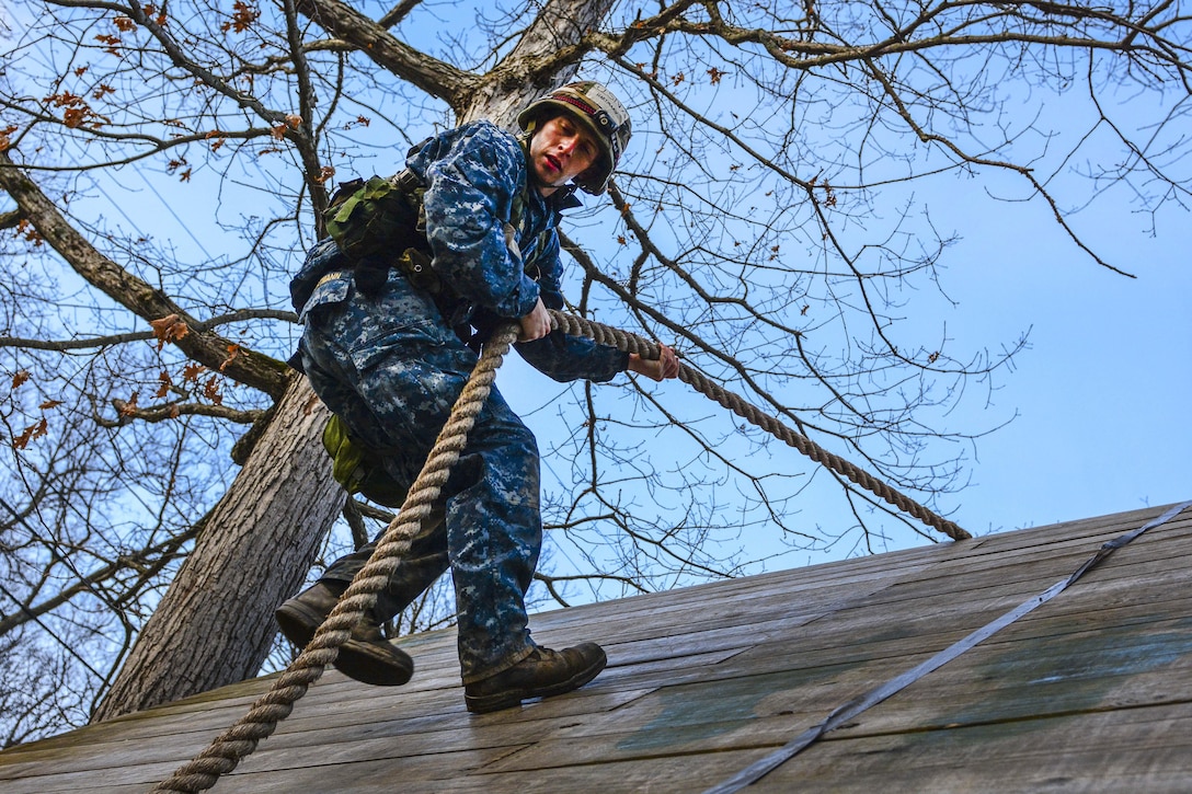 A U.S. Naval Academy midshipman descends down an obstacle course wall during the 2016 Sandhurst Competition at West Point, N.Y., April 9, 2016. The competition tests a team’s ability to perform specified tasks that are both mentally and physically challenging. Army photo by Sgt. 1st Class Brian Hamilton