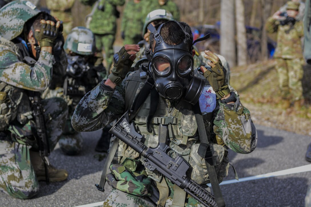 A Chinese army cadet puts on a protective mask at the chemical, biological, radiological and nuclear station during the 2016 Sandhurst Competition at West Point, N.Y., April 9, 2016. Army photo by Sgt. 1st Class Brian Hamilton