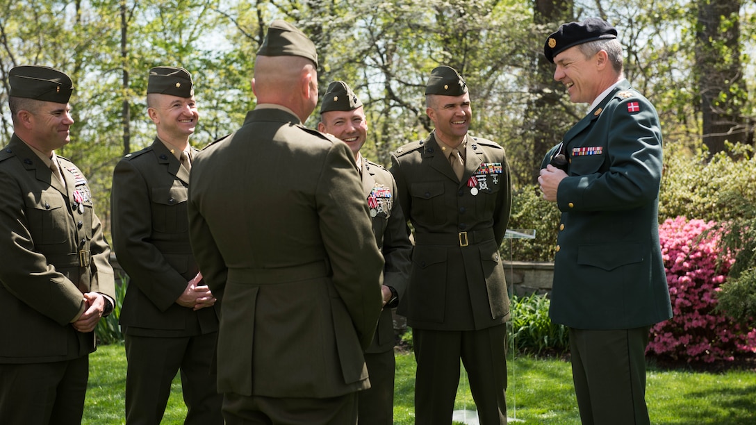 Following the ceremony Marine Corps Major Richard R. Schellhaas, Michael Radynski, Scott Bennignhoff, Justin Jones and Chief Warrant Officer Jake Geary have a conversation with Demarks only four star general Chief of Defence Demark General Peter Bartram. The ceremony took place at the garden in the Danish Embassy in Washington D.C. April 13, 2016.(Marine Corps Photo by Lance Cpl. Timothy R. Smithers/ Released)