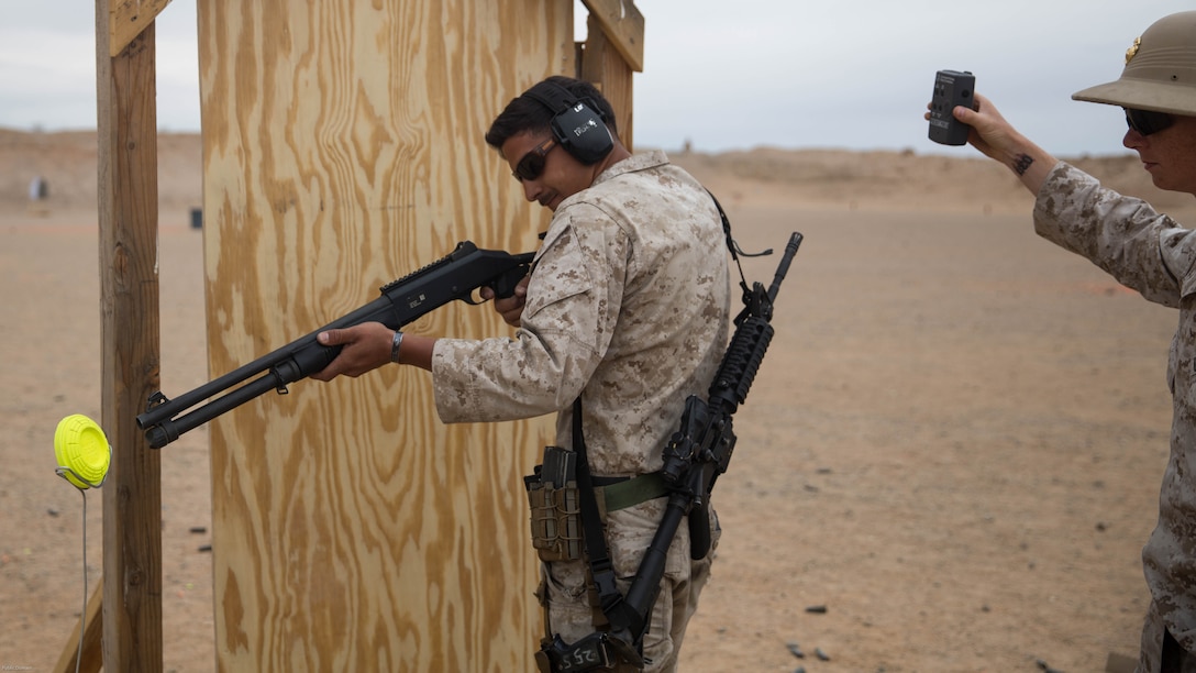 Cpl. Anthony Lubbers, designated marksmanship instructor, Combat Center Marksmanship Training Unit, prepares to breach a door during the Western Regional Combat Match at Marine Corps Air Combat Center, April 8, 2016. 