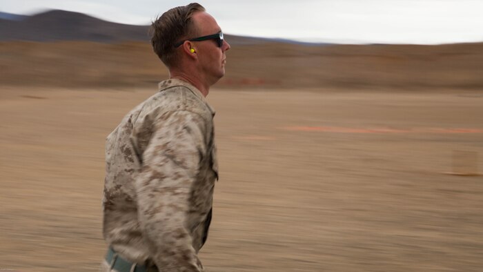 Cpl. Patrik Braun, motor transport operator, Combat Logistics Battalion 7, carries two 30-pound ammo cans before reloading his shotgun at the Western Regional Combat Match at Marine Corps Air Ground Combat Center, April 8, 2016. 