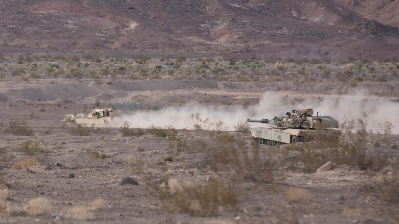 An M1 Assault Breacher Vehicle with Mobile Assault Company, 1st Combat Engineer Battalion, drives to breach a berm in the Blacktop training area as an M1A1 Abrams Main Battle Tank with Company B, 1st Tank Battalion, provides security during the offensive portion of 7th Marine Regiment’s Combined Arms Live Fire Exercise at Marine Corps Air Ground Combat Center April 6, 2016. CALFEX served as the kinetic portion of Desert Scimitar 16, an annual 1st Marine Division training evolution. 