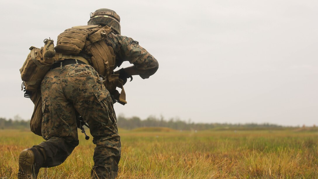 Lance Cpl. Tevin Brown, an automatic rifleman with 2nd Battalion, 8th Marine Regiment, charges toward an objective during a platoon attack training event at Marine Corps Base Camp Lejeune, N.C., April 12, 2016. The training event afforded the Marines an opportunity to develop and improve their strategies under stressful combat situations. 