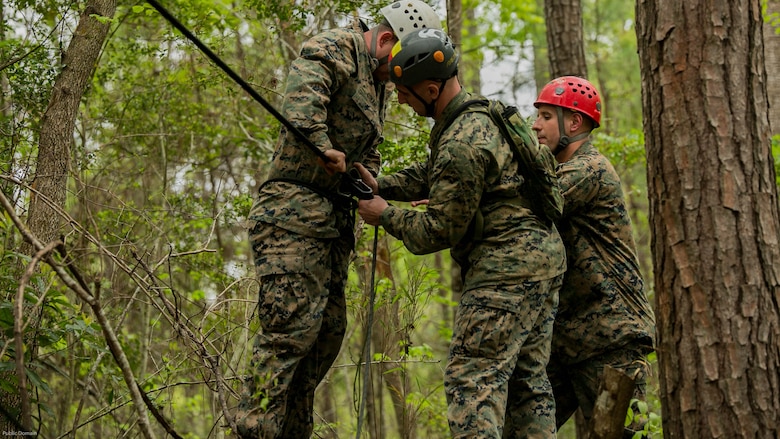 Instructors of the Assault Climbers Course detach Sgt. Chris Ginandt, an instructor for the course, from the one-rope bridge after completing his descent from the top of the cliff face at Marine Corps Base Camp Lejeune, N.C., April 12, 2016. These bridges allow Marines from the 22nd Marine Expeditionary Unit to conduct cliff assaults, and move supplies and themselves safely across a river or cavern.
