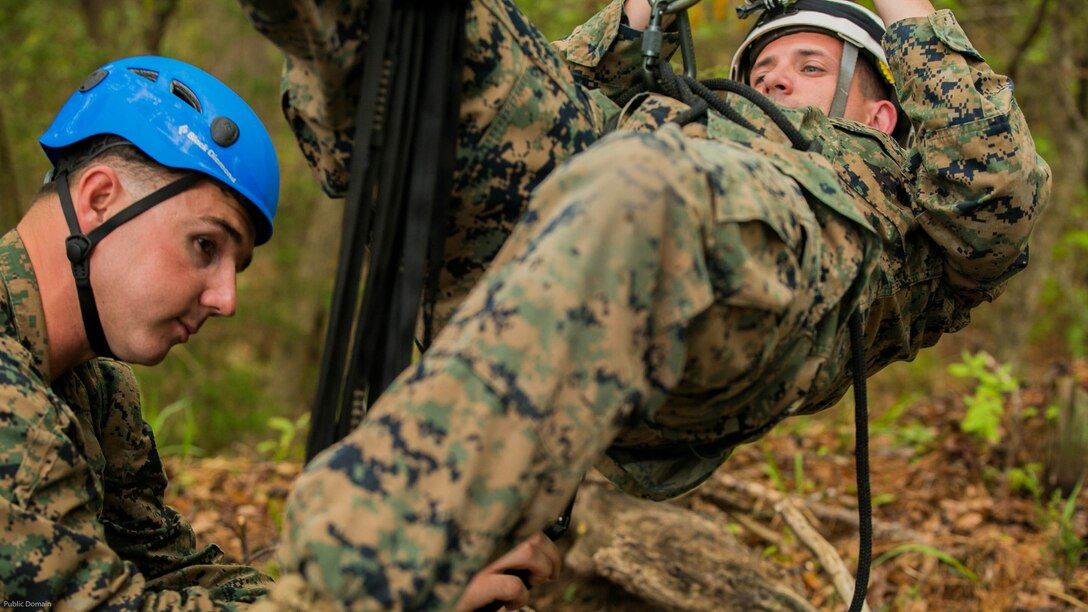 Sgt. Joshua Jelinek, the lead instructor for the Assault Climbers Course (left), attaches Sgt. Chris Ginandt, a fellow instructor, to a suspension bridge during a period of instruction at Marine Corps Base Camp Lejeune, N.C., April 12, 2016. These bridges allow Marines from the 22nd Marine Expeditionary Unit to conduct cliff assaults, and move supplies and themselves safely across a river or cavern.