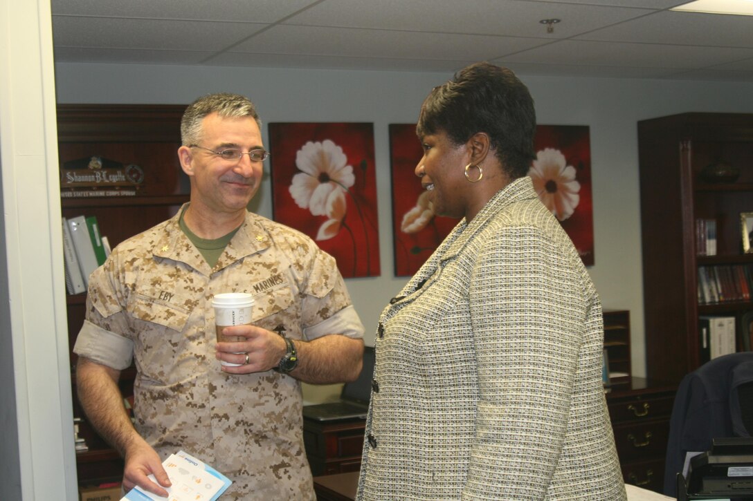 Maj. Michael Eby, Staff Judge Advocate for Marine Corps Base Quantico, talks with Jacqueline Williams, Consolidated Substance Abuse Counseling Center program director, at an Open House in Little Hall Apr. 6.