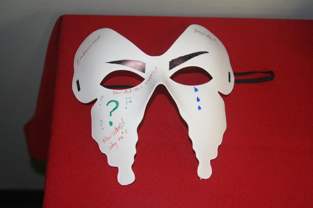 Masks decorated by Marines in the Consolidated Substance Abuse Counseling Center’s intensive outpatient treatment program in March are displayed during a Family Advocacy Program open house Apr. 7. Participants used the masks to express the feelings they use alcohol to cover or hide from the world. April is national Alcohol Awareness Month.