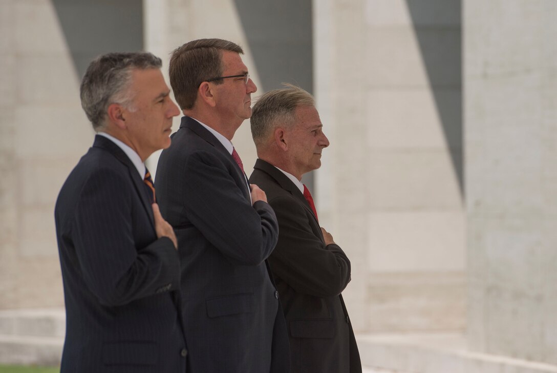Defense Secretary Ash Carter, center, U.S. Ambassador to the Philippines Philip S. Goldberg, left, and a cemetery official render honors as taps is played during a wreath-laying ceremony at the Manila American Cemetery in Manila, Philippines, April 14, 2016. DoD photo by Air Force Senior Master Sgt. Adrian Cadiz