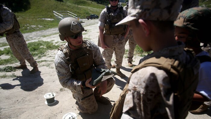 Nathan Aldaco, a 12 year-old boy with hypoplastic left heart syndrome, learns about the power of blasting caps during a Make-A-Wish event supported by 7th Engineer Support Battalion, 1st Marine Logistics Group, at Marine Corps Base Camp Pendleton, California, March 24, 2016. Marines with 7th ESB and Explosive Ordnance Disposal helped to make Nathan’s wish of training with Marines come true by demonstrating the capabilities of their EOD robots and detonating TNT, C4, dynamite and blasting caps, while the heavy equipment operators gave him the opportunity to ride the D7 dozer and the excavator, in which he dug a pit, built a berm, and broke several large tree trunks.  