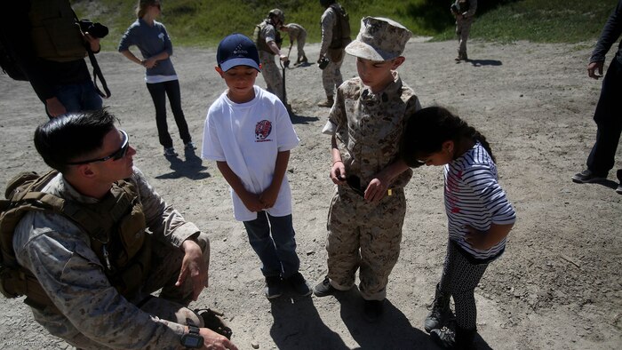 Nathan Aldaco, a 12 year-old boy with hypoplastic left heart syndrome, along with his brother and sister learn about TNT during a Make-A-Wish event supported by 7th Engineer Support Battalion, 1st Marine Logistics Group, at Marine Corps base Camp Pendleton, Calif., March 24, 2016. Marines with 7th ESB and Explosive Ordnance Disposal helped to make Nathan’s wish of training with Marines come true by demonstrating the capabilities of their EOD robots and detonating TNT, C4, dynamite and blasting caps, while the heavy equipment operators gave him the opportunity to ride the D7 dozer and the excavator, in which he dug a pit, built a berm, and broke several large tree trunks. 