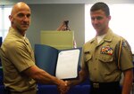 King George High School Naval Junior Reserve Officer Training Corps (NJROTC) cadet Kaleb Sabo receives a letter of appreciation and a John Dahlgren 200th Birthday coin from Naval Surface Warfare Center Dahlgren Division (NSWCDD) Commanding Officer Capt. Brian Durant at the King George County School Board Meeting, April 11.