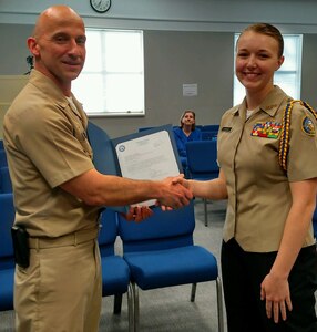 King George High School Naval Junior Reserve Officer Training Corps (NJROTC) cadet Madeline Hassler receives a letter of appreciation and a John Dahlgren 200th Birthday coin from Naval Surface Warfare Center Dahlgren Division (NSWCDD) Commanding Officer Capt. Brian Durant at the King George County School Board Meeting, April 11.