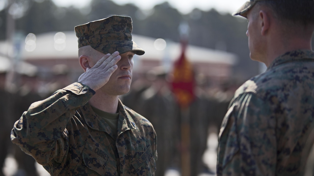 Marine Corps Cpl. Joseph Currey, left, salutes Lt. Col. Jeremy Winters, right, during an award ceremony at Marine Corps Air Station Cherry Point, N.C., March 1, 2016. Currey was awarded the Navy and Marine Corps Commendation Medal for his actions after witnessing an ambulance wreck. Marine Corps photo by Lance Cpl. Austin Lewis