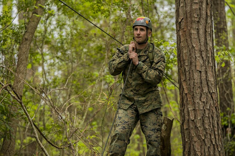 Sgt. Ryan Adams, an instructor for the Assault Climbers Course, tightens the slack from the suspension bridge at Camp Lejeune, N.C., April 12, 2016. These bridges allow Marines from the 22nd Marine Expeditionary Unit to conduct cliff assaults, and move supplies and themselves safely across a river or cavern.