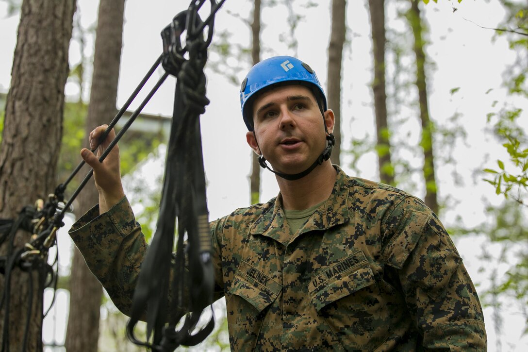 Sgt. Joshua Jelinek, the lead instructor for the Assault Climbers Course, observes the one-rope bridge to ensure it has been properly assembled and is safe for use at Camp Lejeune, N.C., April 12, 2016. These bridges allow Marines from the 22nd Marine Expeditionary Unit to conduct cliff assaults, and move supplies and themselves safely across a river or cavern.