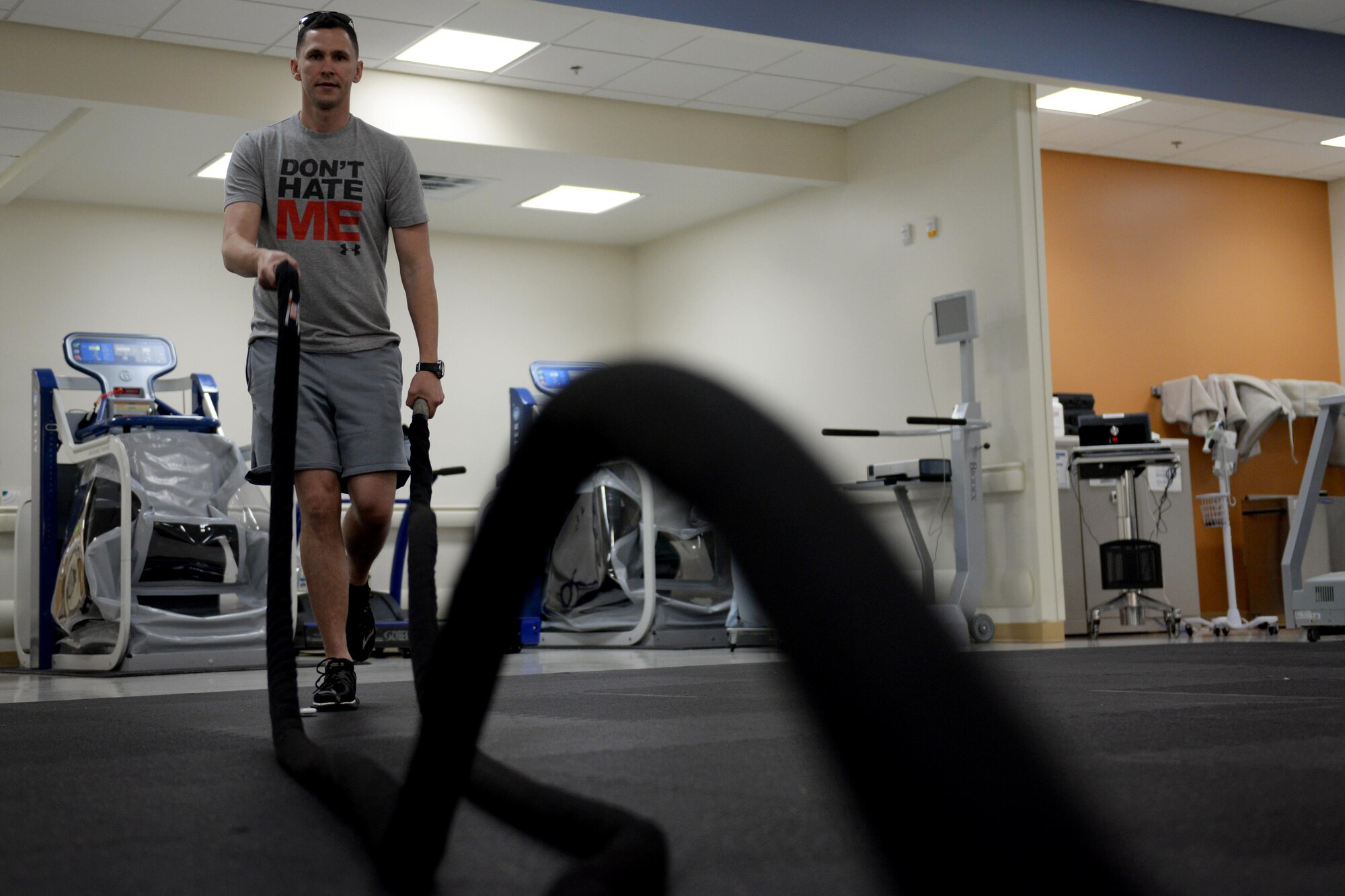 U.S. Marine Corps Staff Sgt. Darien Darland, Keesler Marine Detachment weather instructor, swings battle ropes while balancing on one leg in the physical therapy department, April 7, 2016, Keesler Air Force Base, Miss. When recovering from a leg injury, balancing on one leg can be difficult. As clients progress in their therapy, technicians increase exercise difficulty. Incorporating battle ropes into a single leg stability exercise adds an extra challenge to the client. (Air Force Photo by Airman 1st Class Travis Beihl)