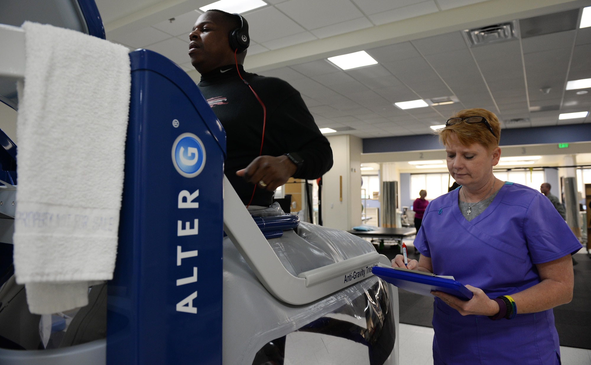 Sharay Windham, 81st Medical Support Squadron licensed physical therapist assistant, takes notes as Master Sgt. Byron Self, 81st Security Forces Squadron flight chief, runs on an anti-gravity treadmill in the Physical Therapy department, April 6, 2016, Keesler Air Force Base, Miss. The anti-gravity treadmill is used to help rehabilitate clients who have injuries to their lower limbs by decreasing the amount of weight on the client’s joints which helps with recovery after injury or surgery. (Air Force Photo by Airman 1st Class Travis Beihl)
