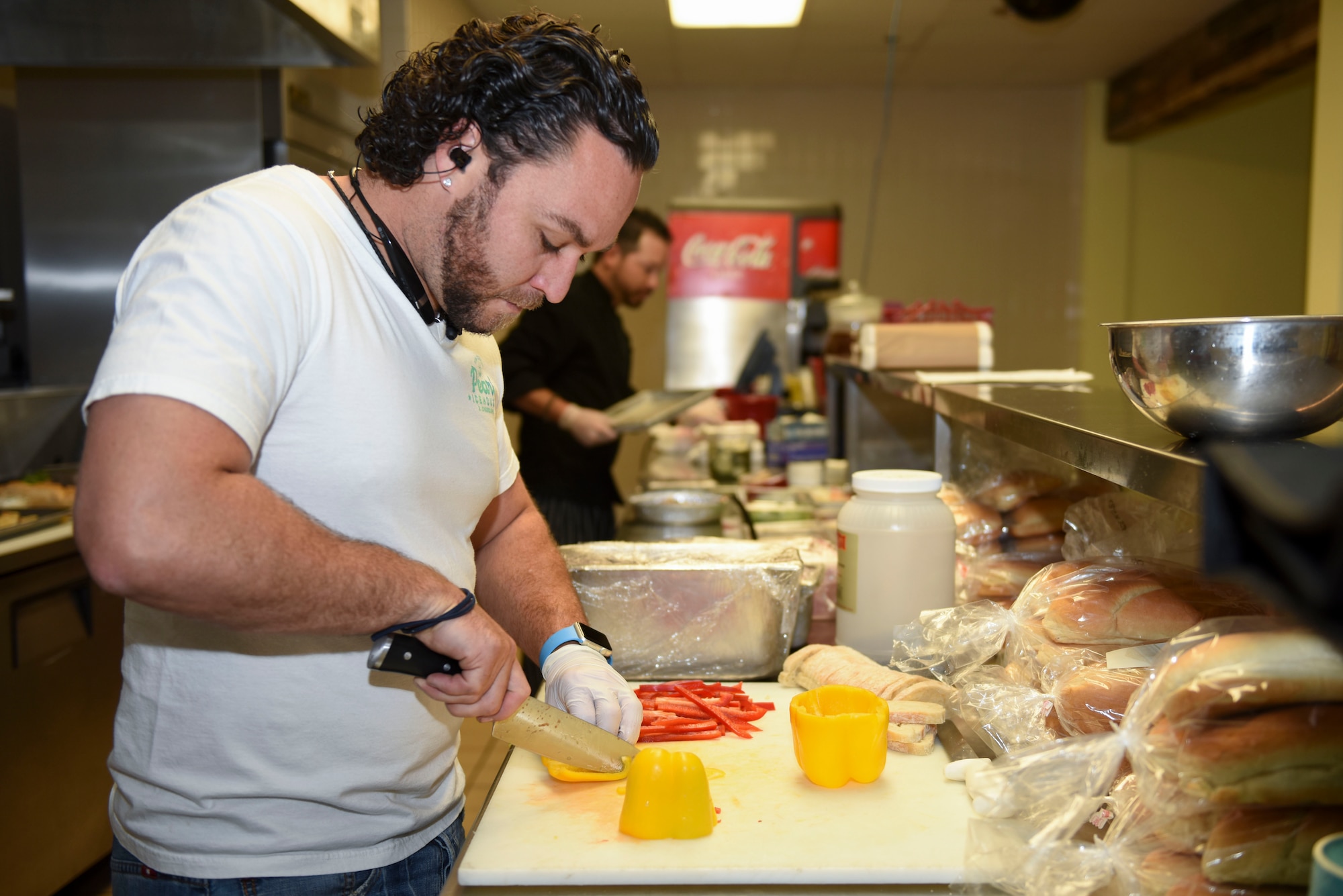 Tanner D. Todd, local restaurant chef, cuts fresh vegetables for the grand opening of a new café at the Event Center on Goodfellow Air Force Base, Texas, April 13, 2016. The café will serve multiple dishes for all Goodfellow personnel. (U.S. Air Force photo by Airman Chase Sousa/Released) 