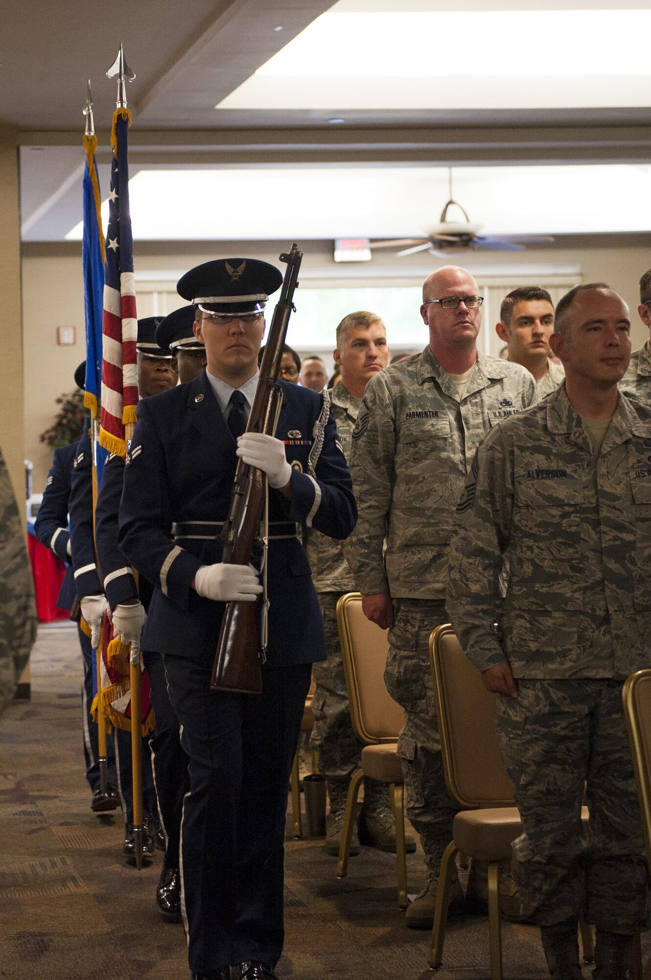 The Moody Base Honor Guard presents the colors while Airmen stand at attention during a volunteer recognition ceremony, April 13, 2016, at Moody Air Force Base, Ga. The ceremony honored several squadrons and groups for the hours they volunteered during 2015. (U.S. Air Force photo by Airman 1st Class Lauren M. Hunter/Released)