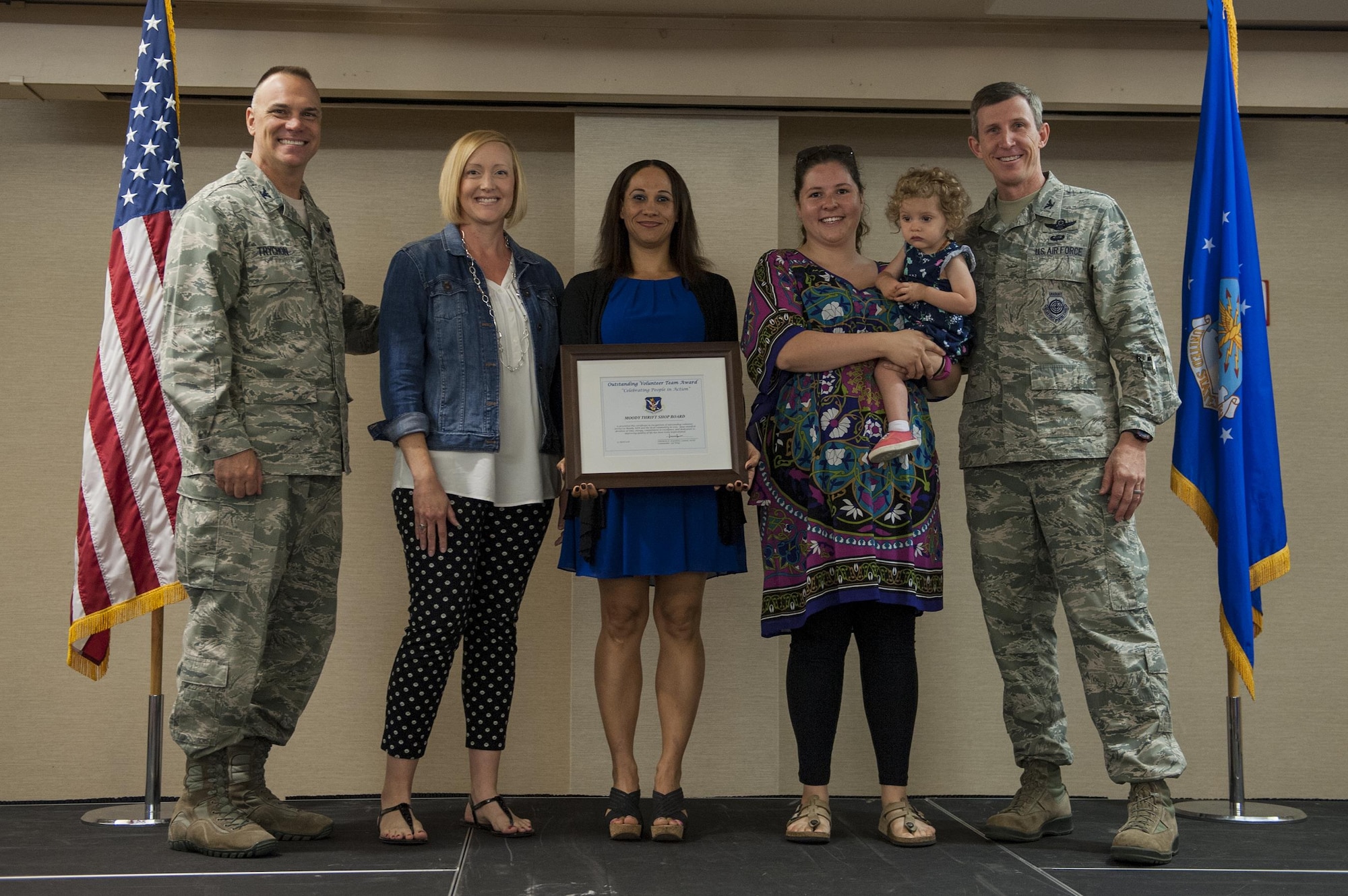 Moody’s thrift shop receives an Outstanding Volunteer Team Award from U.S. Air Force Col. Thomas Kunkel, right, 23d Wing commander, and Col. Eric Trychon, left, 93d Air Ground Operations Wing vice commander, during a volunteer recognition ceremony, April 13, 2016, at Moody Air Force Base, Ga. The Outstanding Volunteer Team Award is given to groups who promote an atmosphere of teamwork in their organization and whose contributions through volunteering have greatly impacted Moody Air Force Base. (U.S. Air Force photo by Airman 1st Class Lauren M. Hunter/Released)