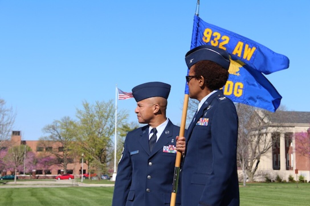 The 932nd Airlift Wing's Medical Group met out on the Scott Air Force Base parade field recently for a group photo and review of uniforms.  Watching the Airmen get into position are Chief Master Sgt. George Vaughn and the commander of the 932nd Medical Group, Col. Vanessa Mattox.  It took about an hour from start to finish to complete the project.  (U.S. Air Force photo by Maj. Stan Paregien)