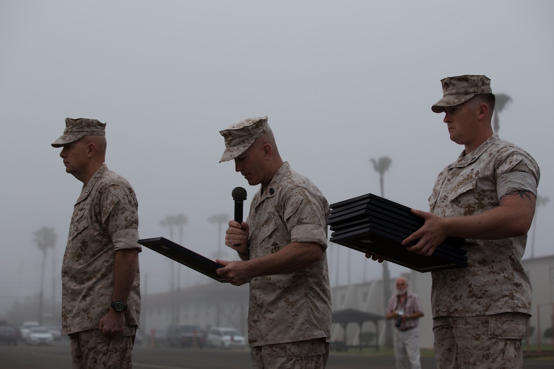 MARINE CORPS BASE CAMP PENDLETON, Calif. – Lieutenant General David Berger, I Marine Expeditionary Force commanding general, and Sgt. Maj. Bradley Kasal, I MEF Sergeant Major, present meritorious promotion certificates to Marines from across Camp Pendleton during a meritorious promotion ceremony April 4, 2016. Meritorious promotions are a way for the Marine Corps to reward outstanding performance and highlight the dedication and spirit among those who serve within it. (Marine Corps photo by Cpl. Jonathan Boynes/ Not Released)