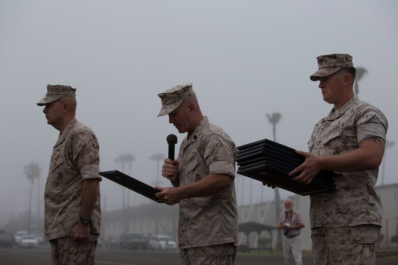MARINE CORPS BASE CAMP PENDLETON, Calif. – Lieutenant General David Berger, I Marine Expeditionary Force commanding general, and Sgt. Maj. Bradley Kasal, I MEF Sergeant Major, present meritorious promotion certificates to Marines from across Camp Pendleton during a meritorious promotion ceremony April 4, 2016. Meritorious promotions are a way for the Marine Corps to reward outstanding performance and highlight the dedication and spirit among those who serve within it. (Marine Corps photo by Cpl. Jonathan Boynes/ Not Released)