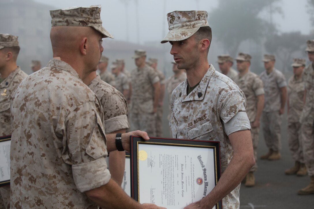 MARINE CORPS BASE CAMP PENDLETON, Calif. – Lieutenant General David Berger, I Marine Expeditionary Force commanding general, presents SSgt. Kurtis Carpenter, an armorer with 1st Intelligence Battalion, and Louisa, VA. a meritorious promotion certificate on Camp Pendleton, April 4, 2016. Meritorious promotions are a way for the Marine Corps to reward outstanding performance and highlight the dedication and spirit among those who serve within it. (Marine Corps photo by Cpl. Jonathan Boynes/Released)