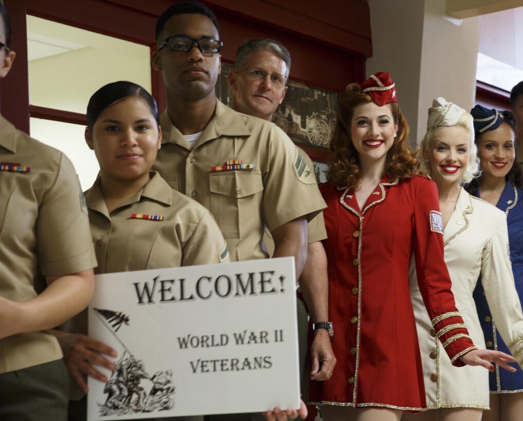 Marines with Marine Forces Reserve and the Victory Belles, the National World War II Museum’s vocal trio, wait for veterans participating in the Soaring Valor program to exit the terminal at Louis Armstrong New Orleans International Airport, April 13, 2016. The Soaring Valor program was created by actor Gary Sinise to honor veterans of World War II for their sacrifices and to give them a special tour of the National World War II Museum. (U.S. Marine Corps photo by Cpl. Ian Leones/ Released)