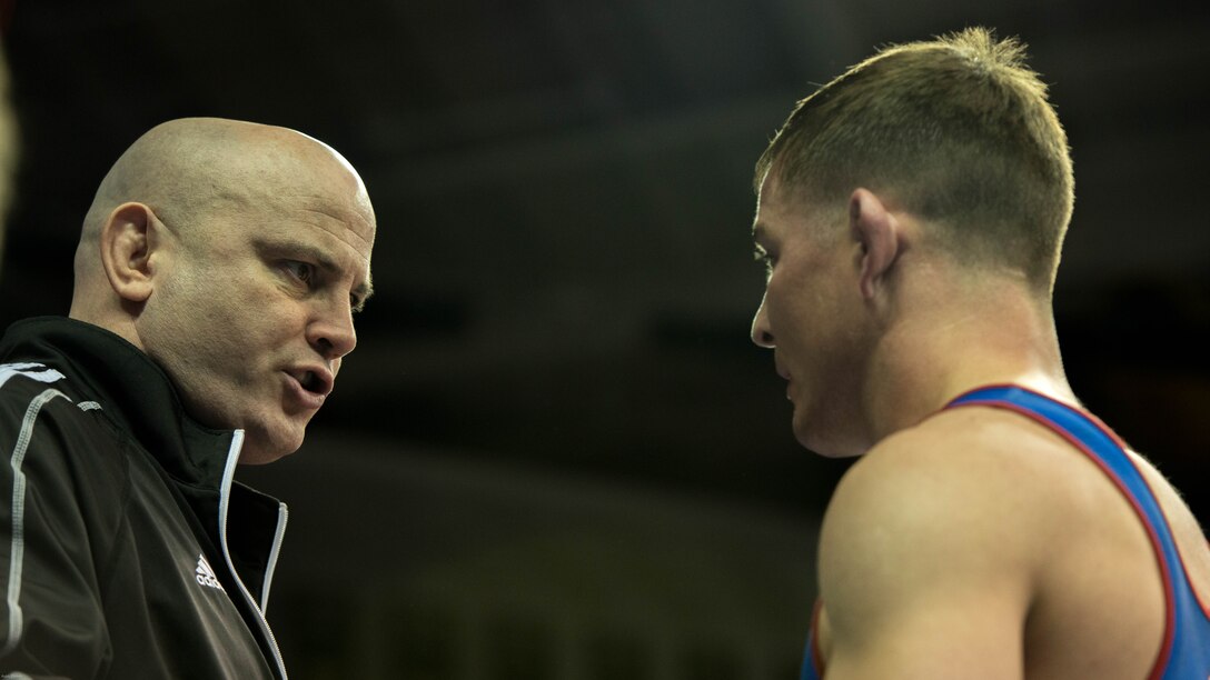 Jason Loukides, head coach for the All-Marine Wrestling Team, gives advice to Capt. Bryce Saddoris during the 2016 U.S. Olympic Wrestling Trials in Iowa City, Iowa April 9. USA Wrestling named Loukides the Greco-Roman Coach of the Year for 2015.