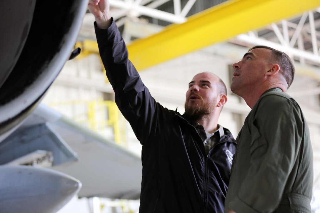Havelock Mayor William Lewis, left, asks Maj. Nathaniel Baker questions about the equipment on an EA-6B Prowler during an aircraft hangar tour at Marine Corps Air Station Cherry Point, N.C., April 6, 2016. According to Lewis, the tour was part of his efforts to strengthen the already well-established relationship between the Havelock and Cherry Point communities. He looks to grow community ties with the air station by understanding the mission of the 2nd Marine Aircraft Wing and its squadrons, said Lewis. Baker is the assistant operations officer of Marine Aircraft Group 14. (U.S. Marine Corps photo by Lance Cpl. Mackenzie Gibson/Released.) 